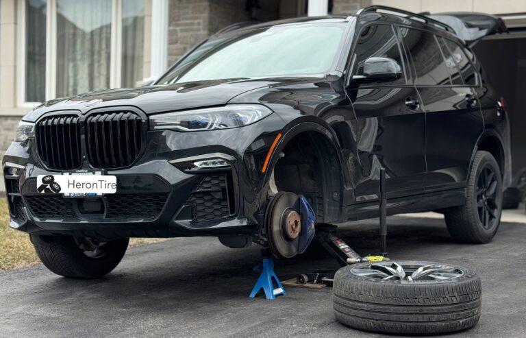 Photo Of a BMW X7 Getting Tires Changed